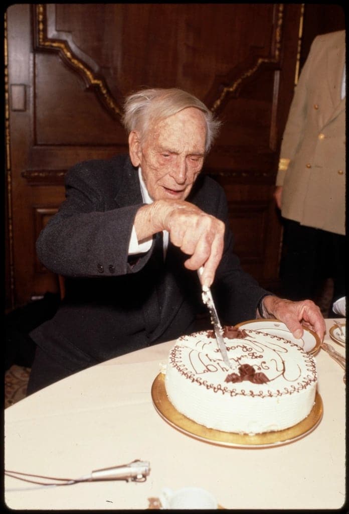 A grandfather cutting his birthday cake