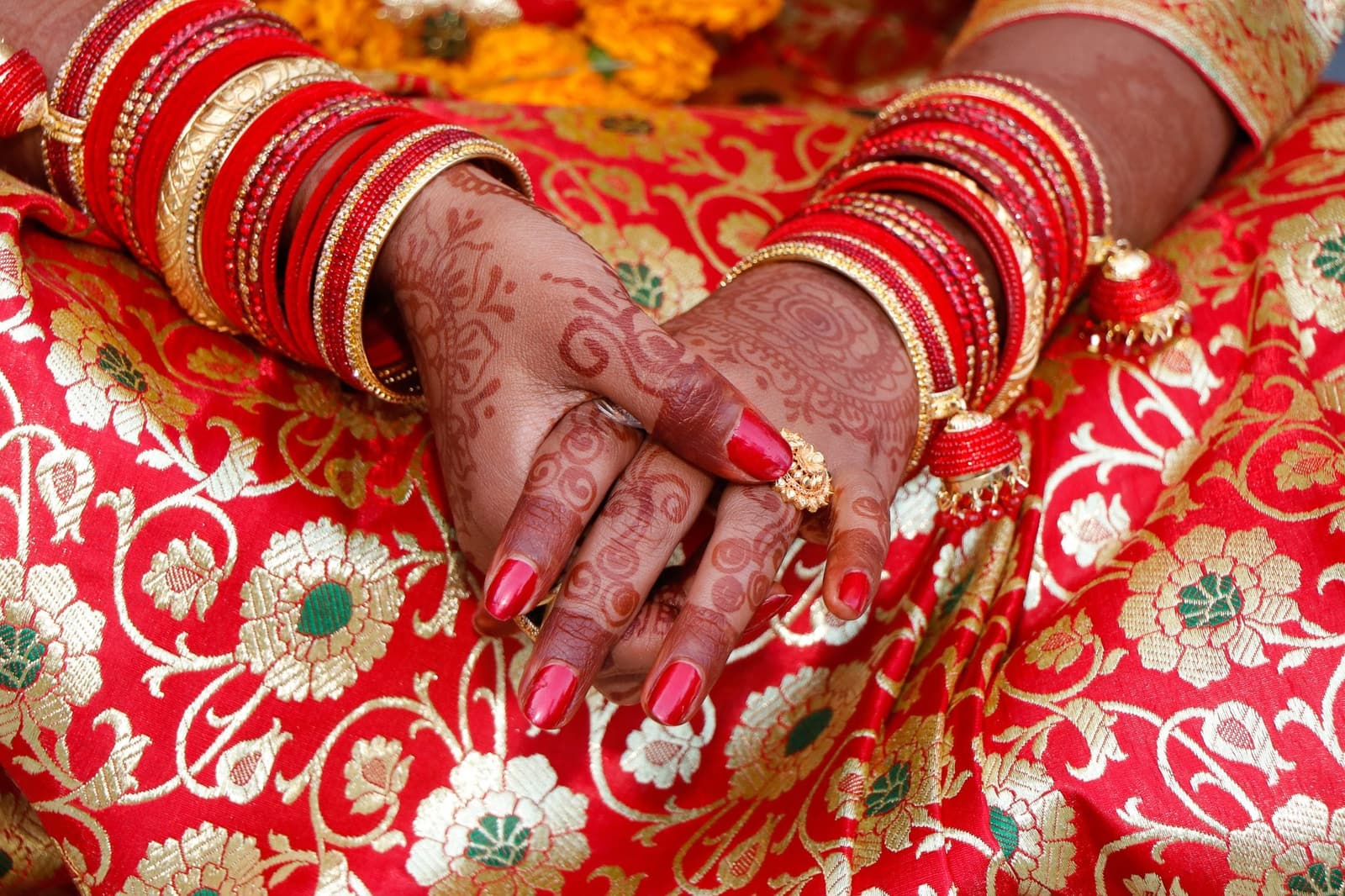 A bride's hands with mehendi and bangles