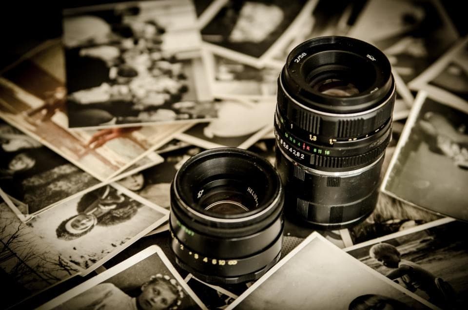 Old photographs scattered with camera lenses