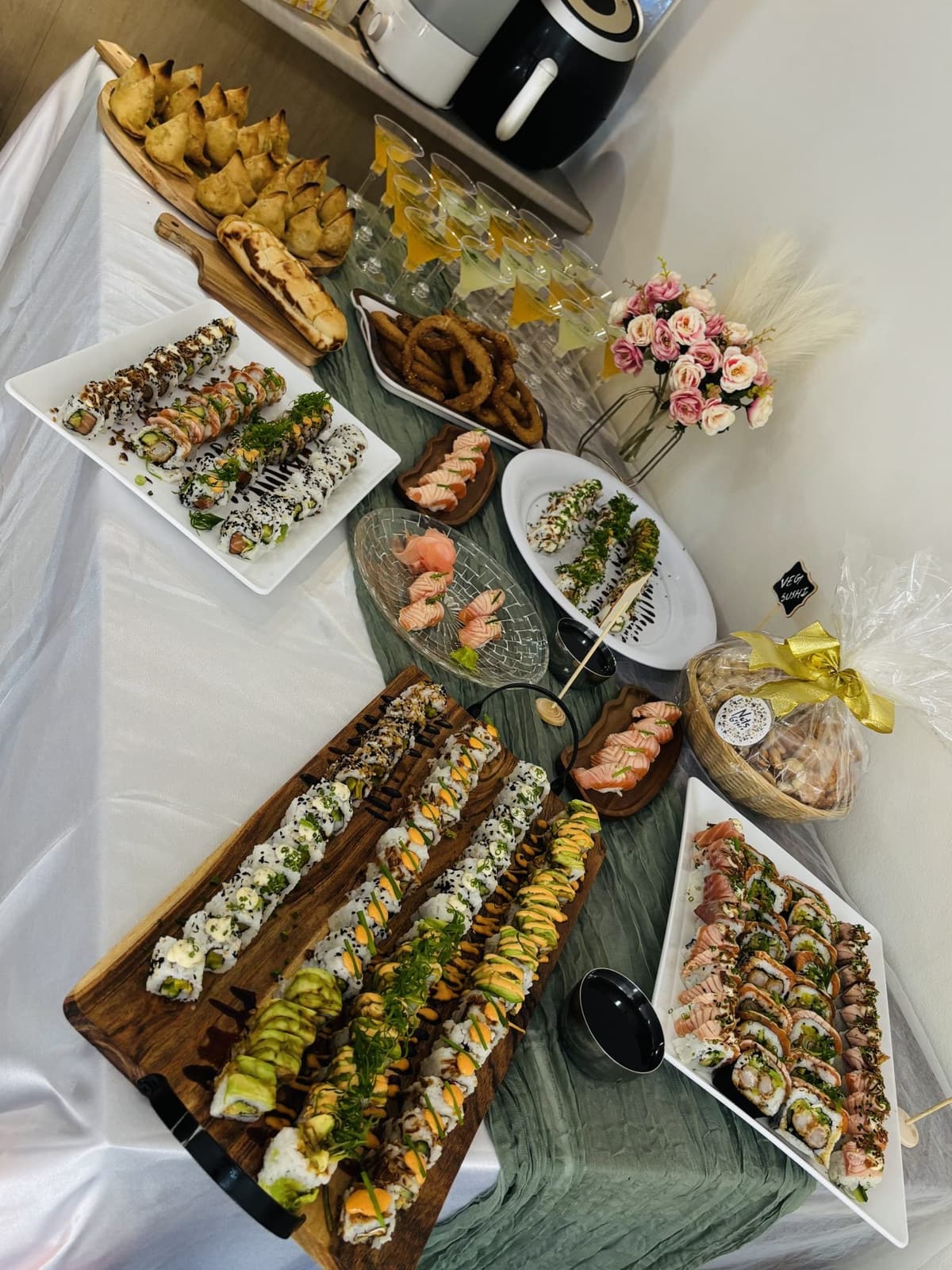A table of sel roti and snacks
