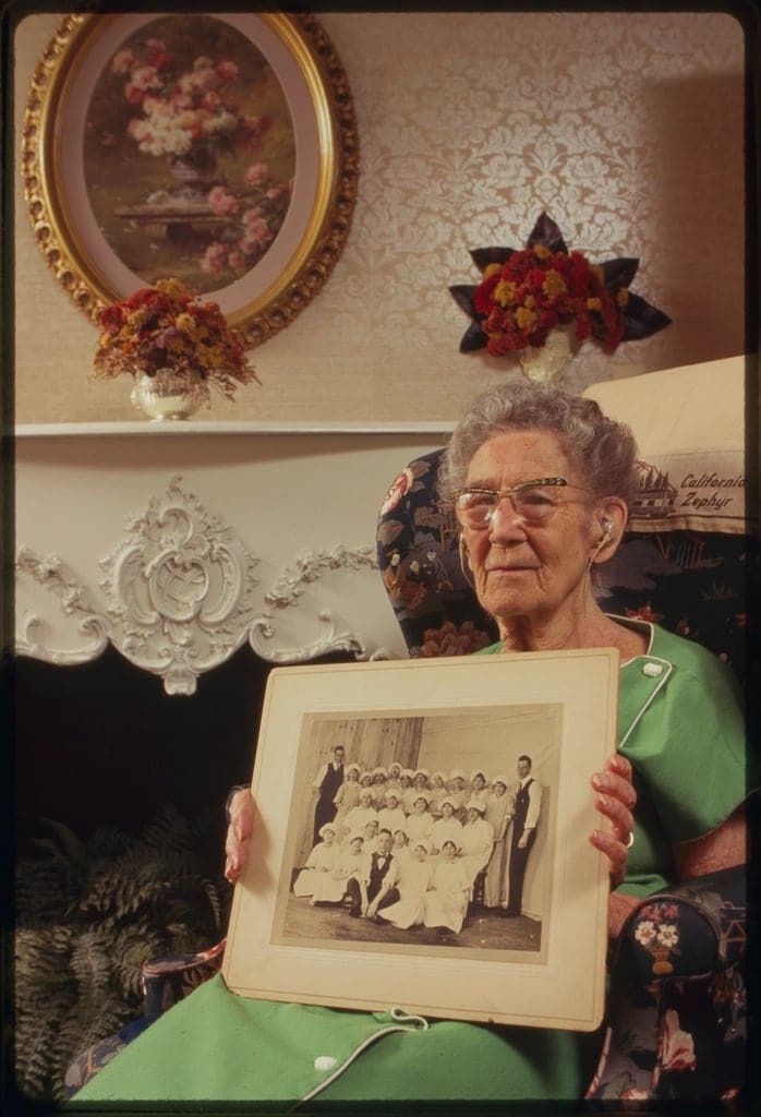 A grandmother holding an old photograph